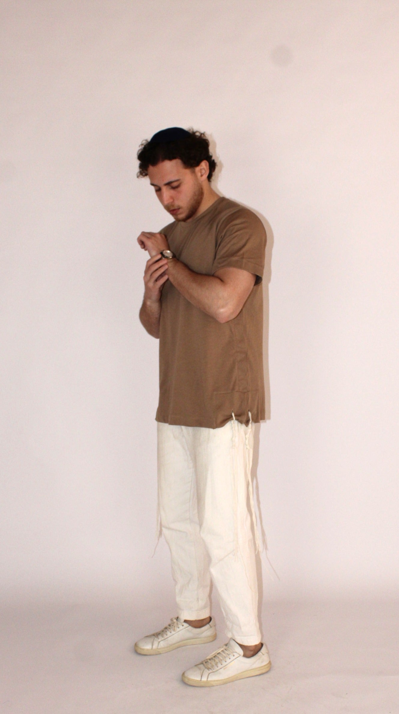 Model wears Classic Fit Brown Tzitzit T-Shirt from side with different pose