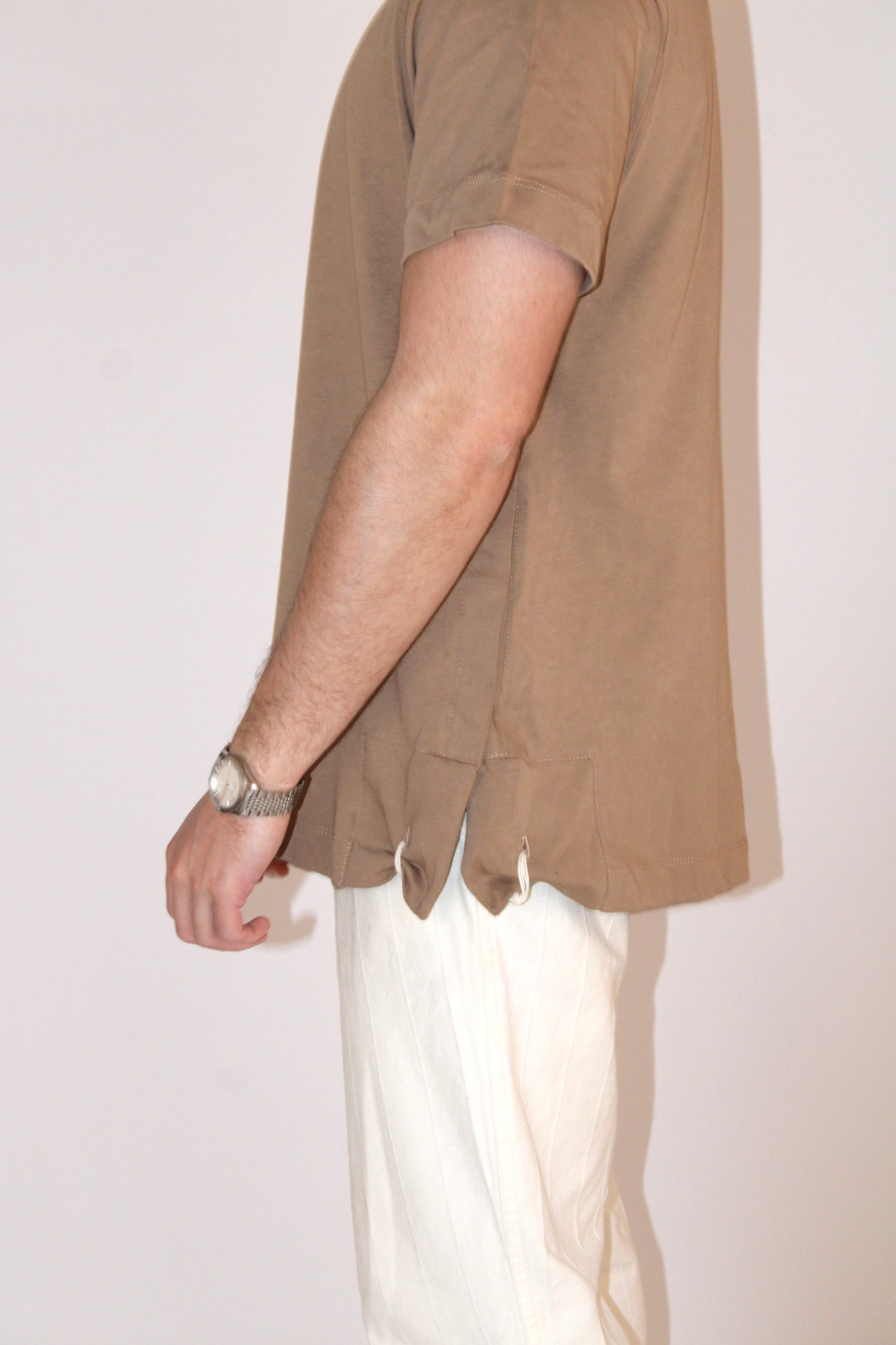 Model wears Classic Fit Brown Tzitzit T-Shirt from side with closer look